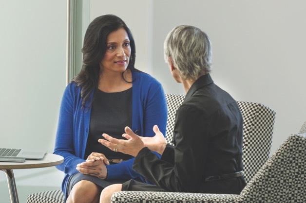 Two women talking in an office setting